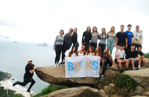 CTeen Bucks County teens holding a Bucks banner on a mountain lookout