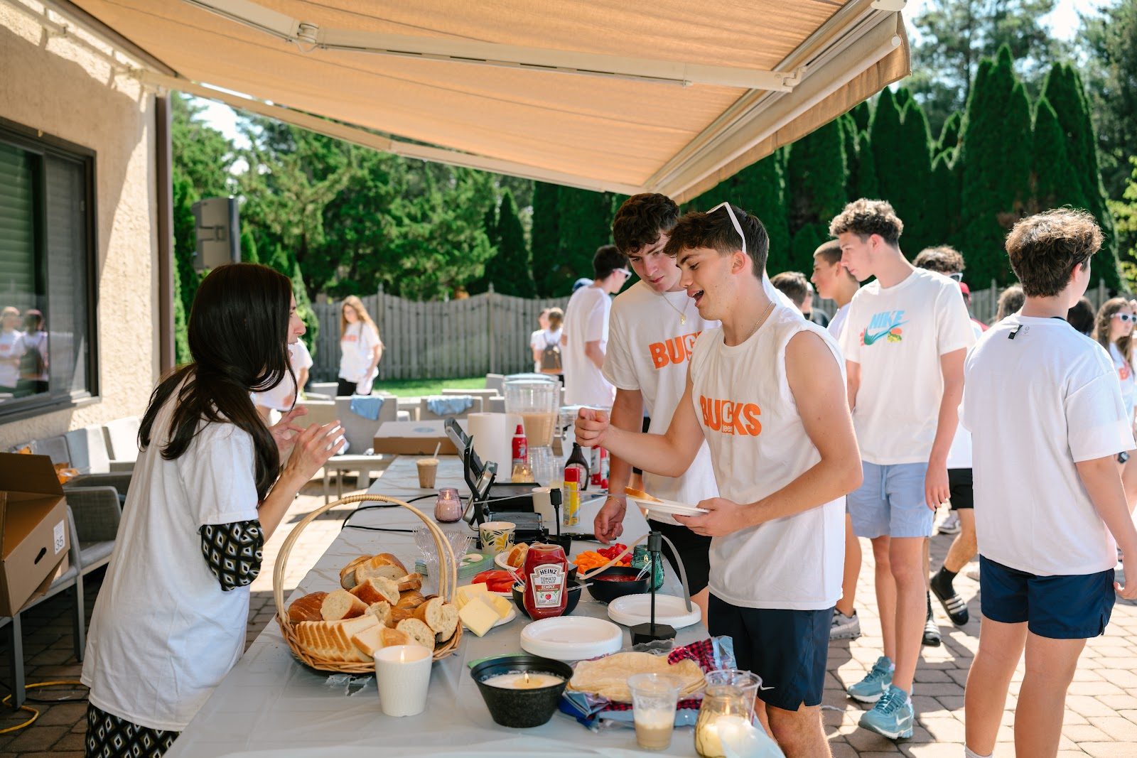 Younger CTeen Bucks teens playing lawn games at a kickoff event